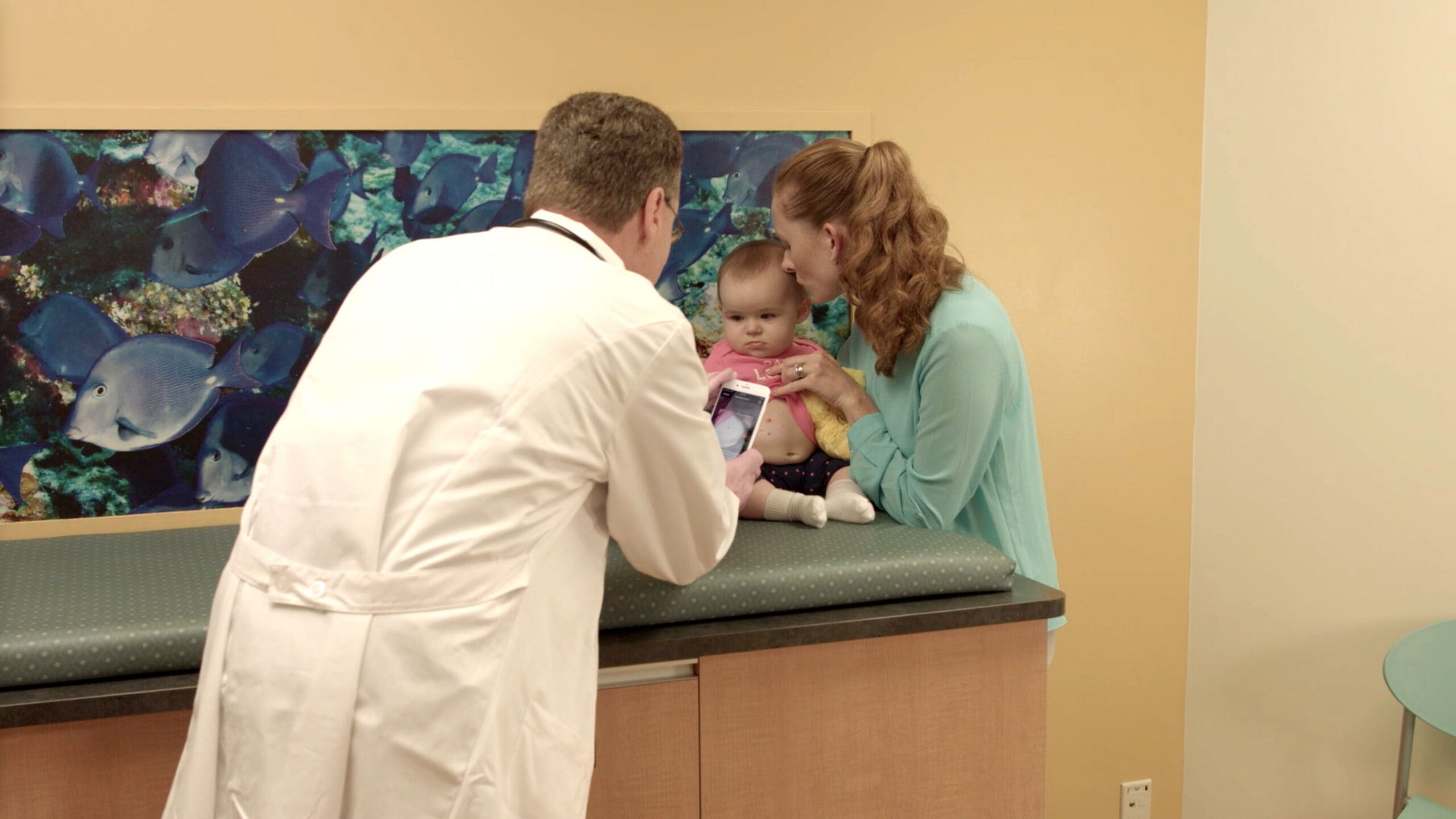Doctor Using VisualDx Plus DermExpert with Pediatric Patient
